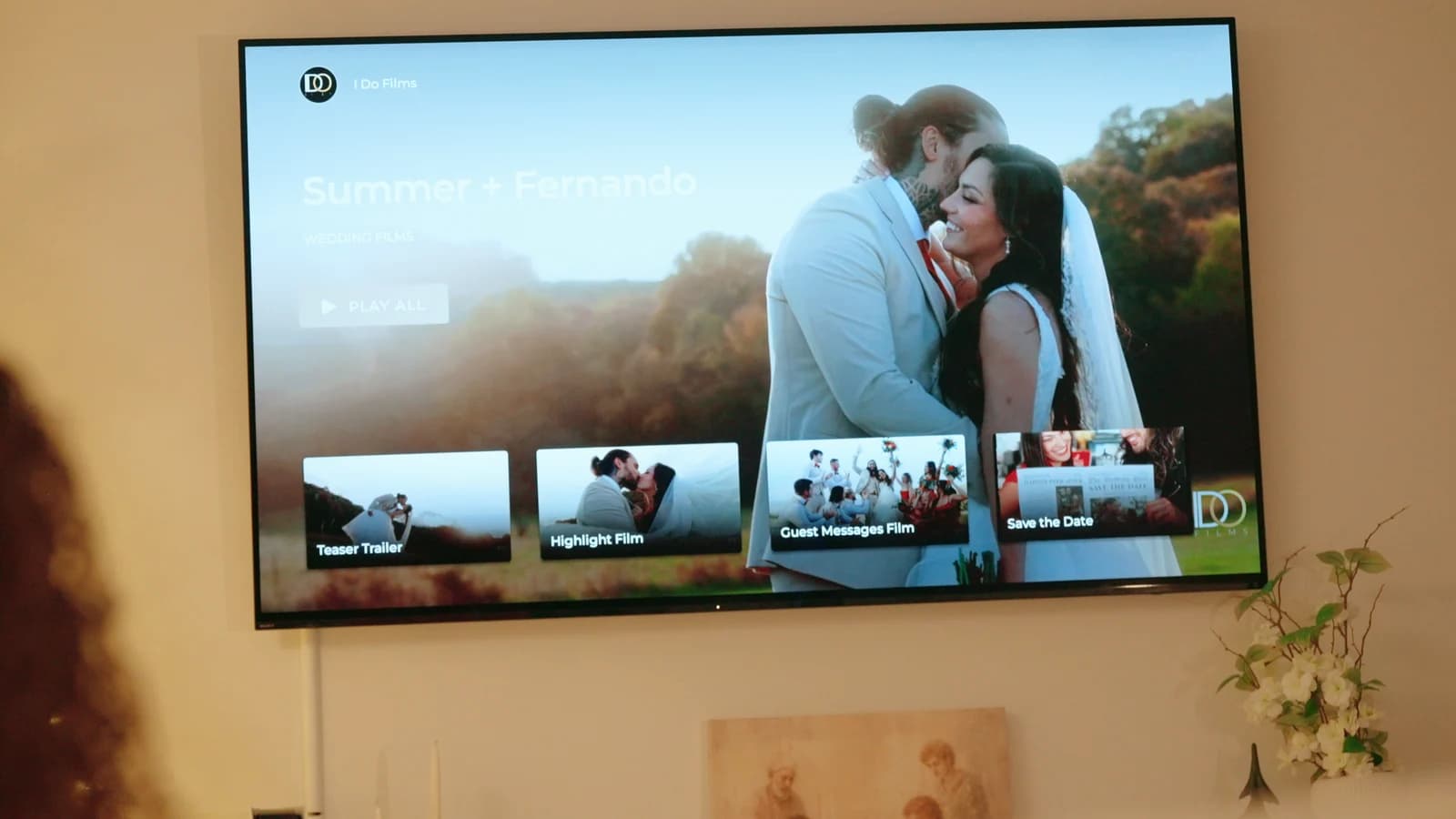 Their private film website open on the living-room television, the row of their films along the bottom.